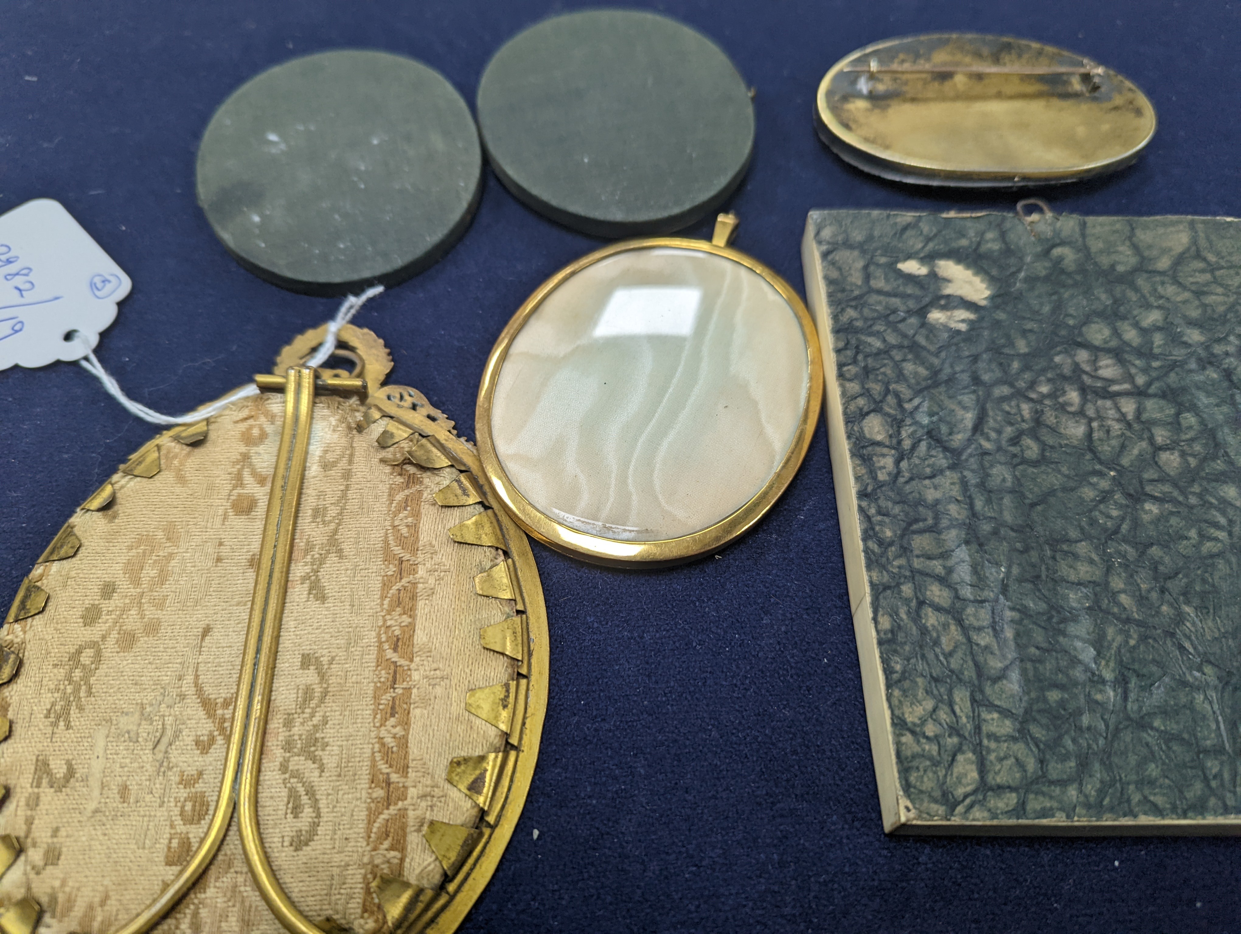A paste and enamel framed Portrait miniature on ivory, 9.2cm and four other portrait miniatures (three on ivory)